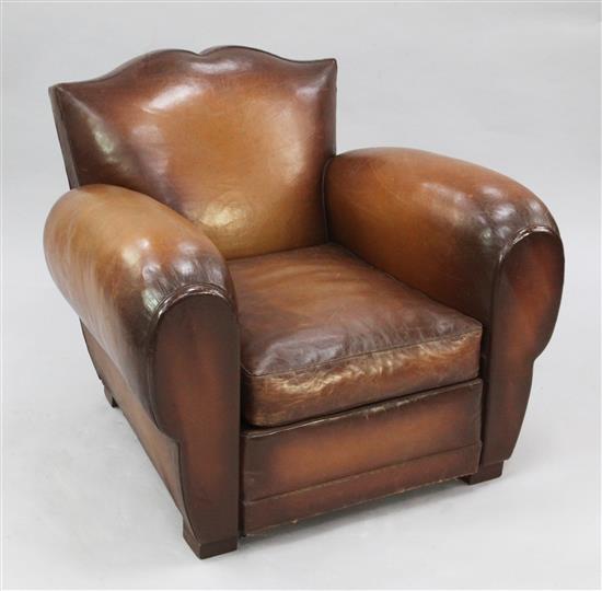 A 1930s brown leather upholstered armchair,